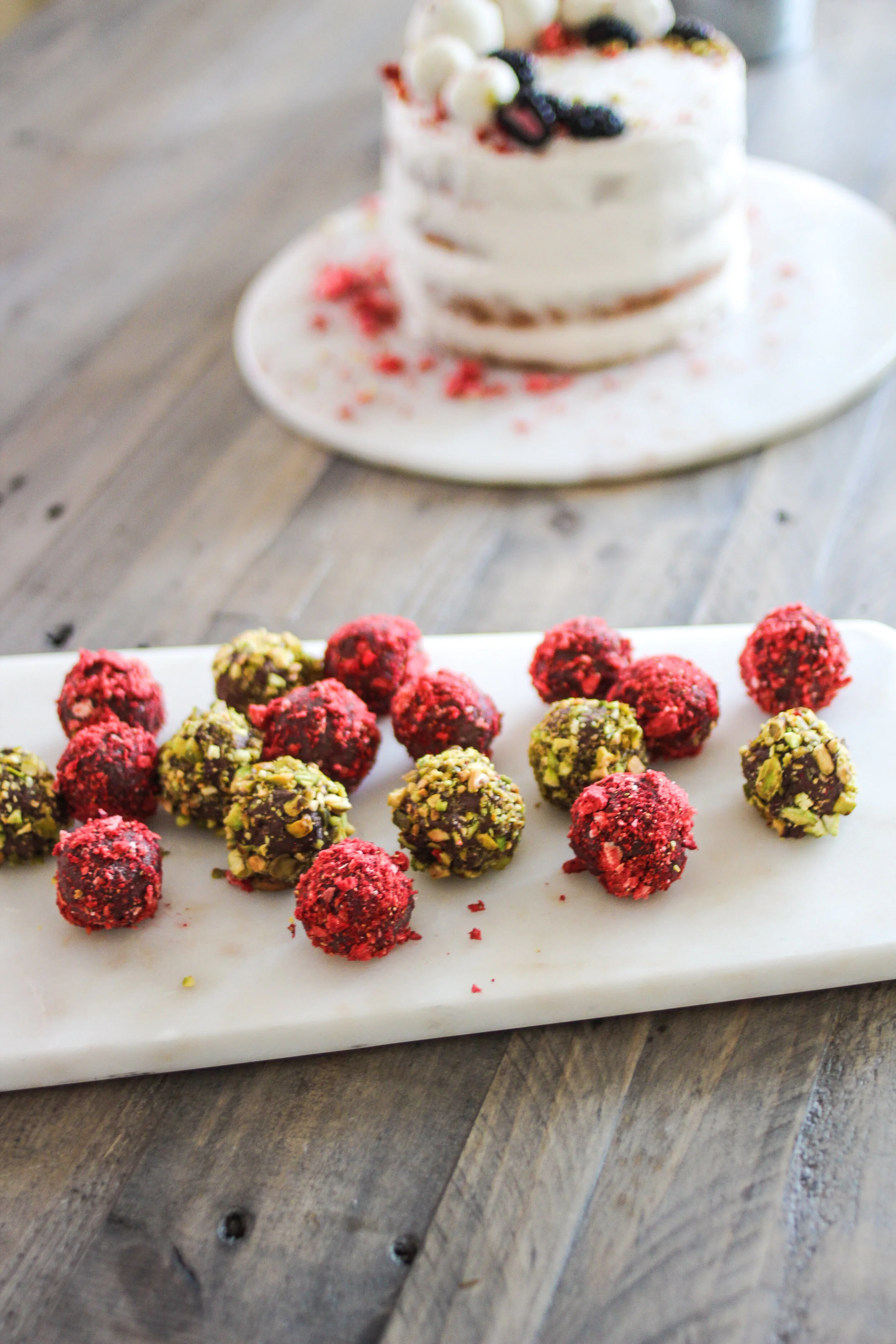 Raw Chocolate Truffles for my birthday this summer, and Shanti Kitchen Raw Carrot Cake with Coconut Meat Frosting in the background.
