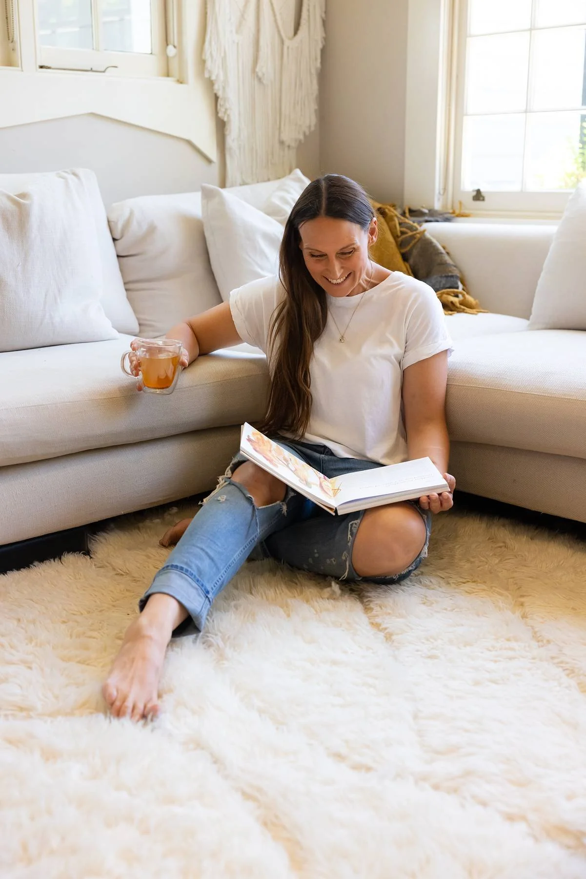 Nancy reading a birth and yoga book in her home