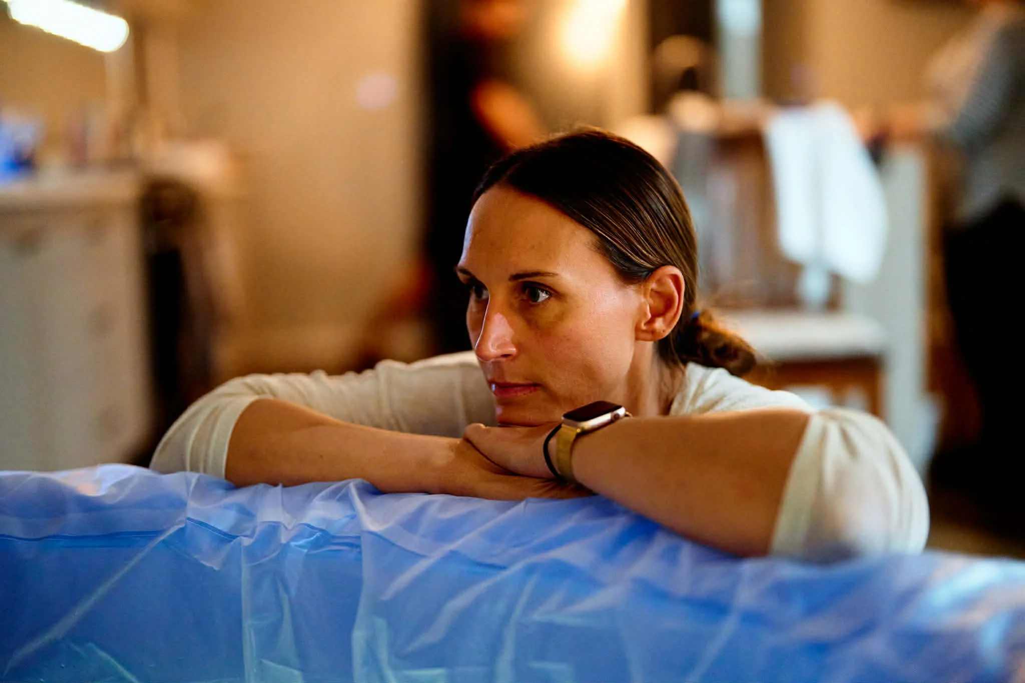 Nancy watching intently at the labouring woman in the birth pool