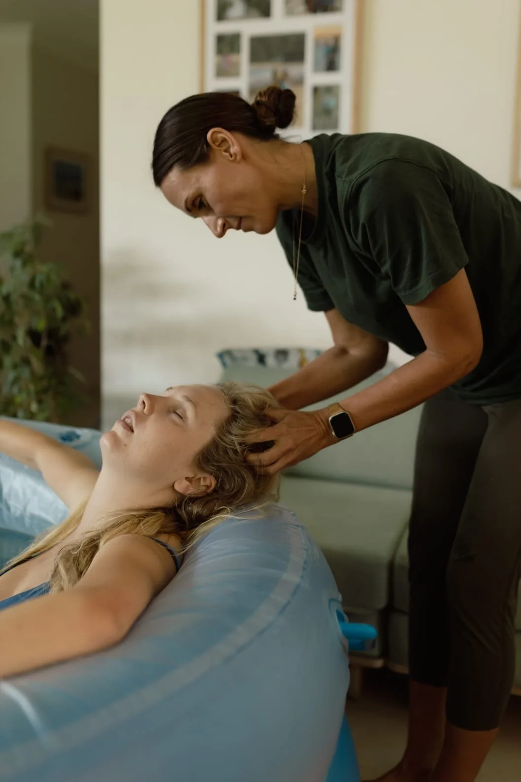 Nancy giving her doula client a head massage during labour whilst having a water birth