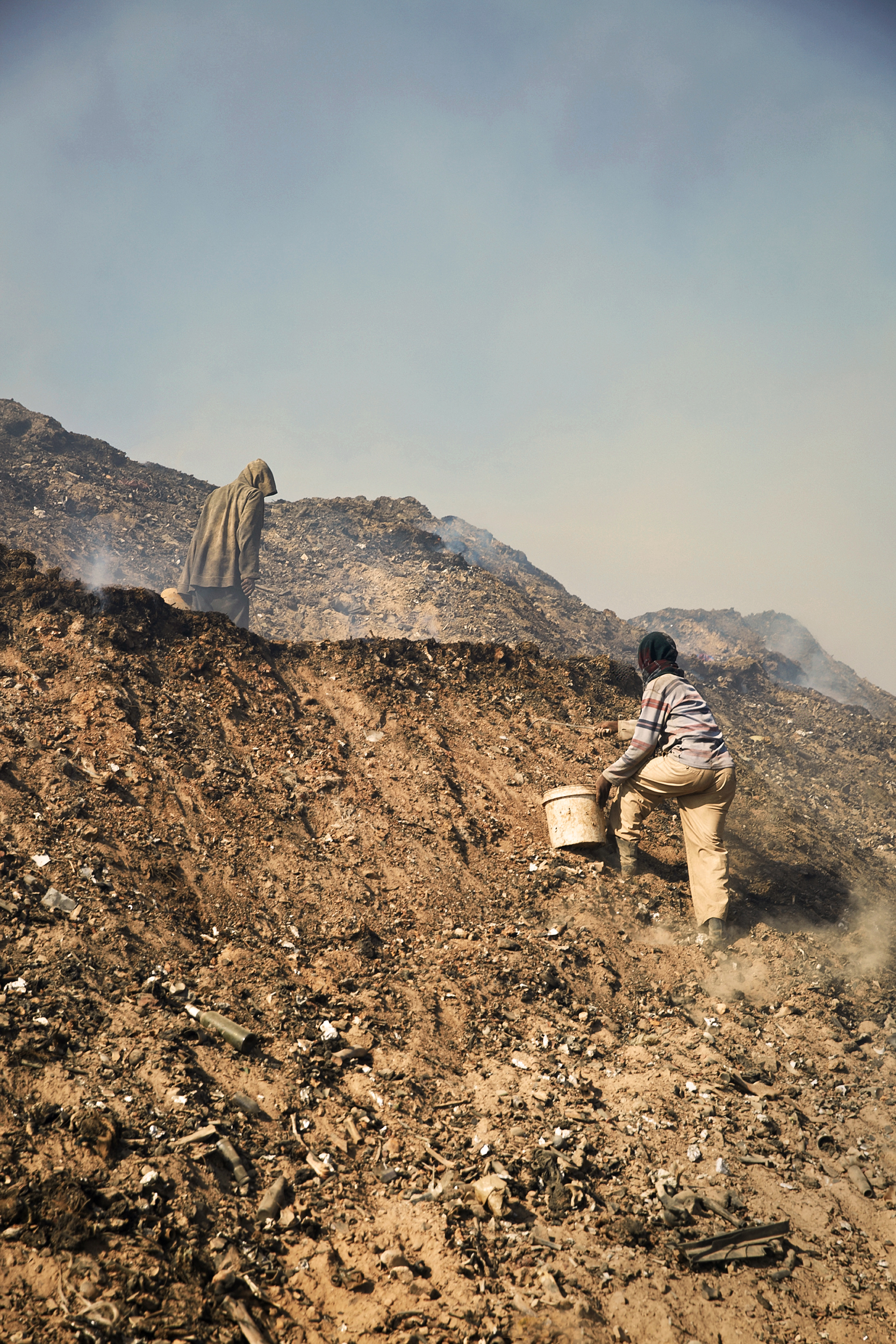  "Pickers"  searching for materials to resell as the eek out a living at the Koshe Landfill site.&nbsp;Each picker specializes in metal, foam or PVC pipe that they'll later resell. Most make less than $1 per day, having few other options for work.  &