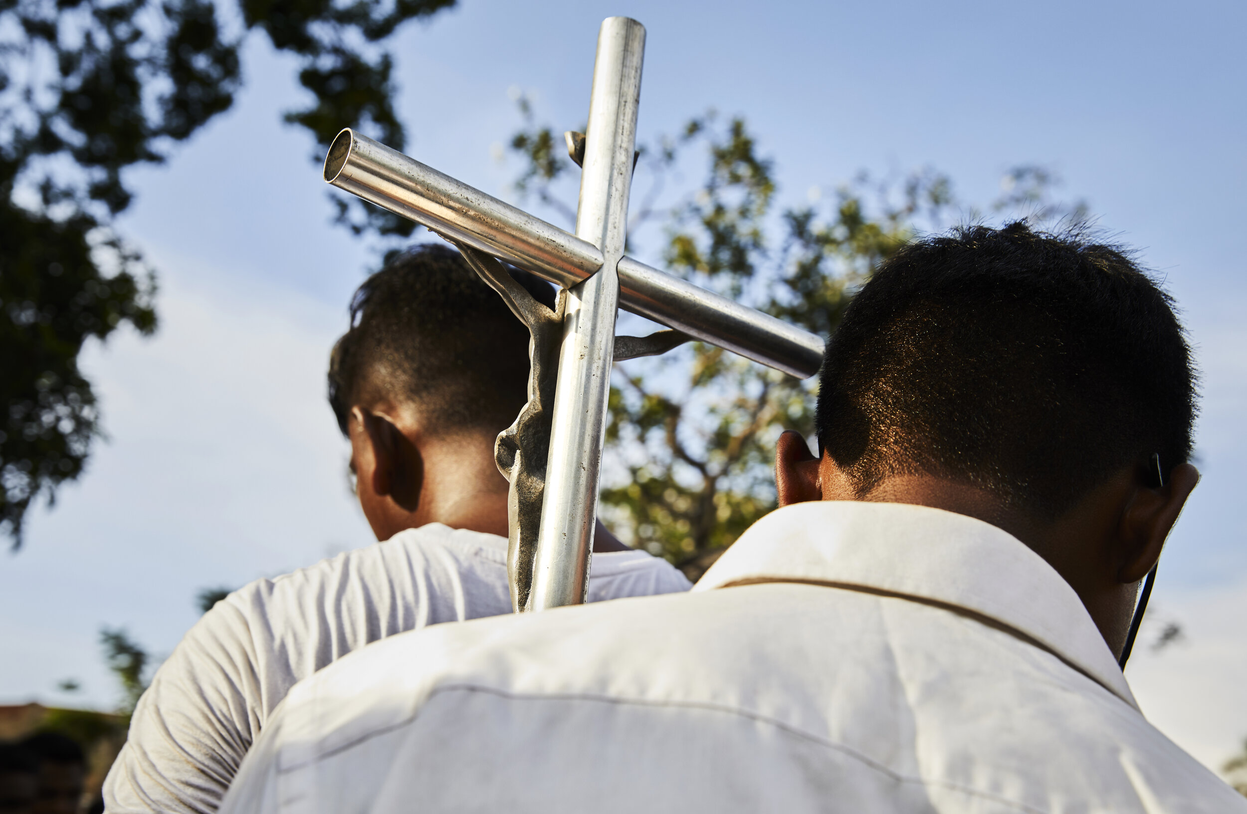  Altar boys carry a cross at one of the many funeral processions for the 260 victims of  the Easter Sunday bombings in Colombo, Sri Lanka 