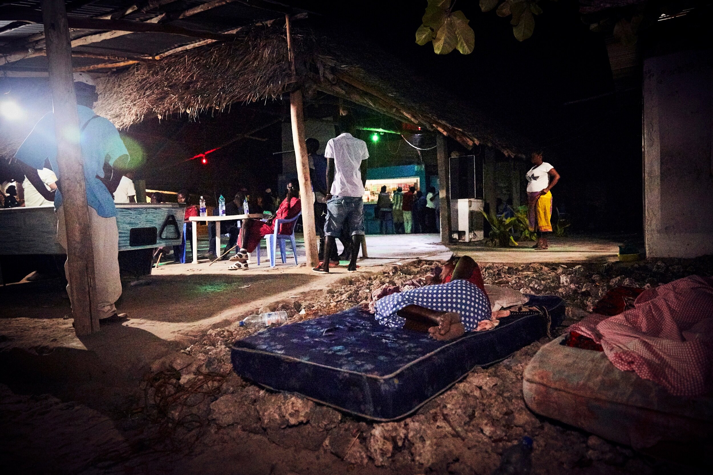  On a slow night, the women have dragged their sleeping mattresses outside, hoping to catch a breeze in Zanzibar's 90+ degree weather. 