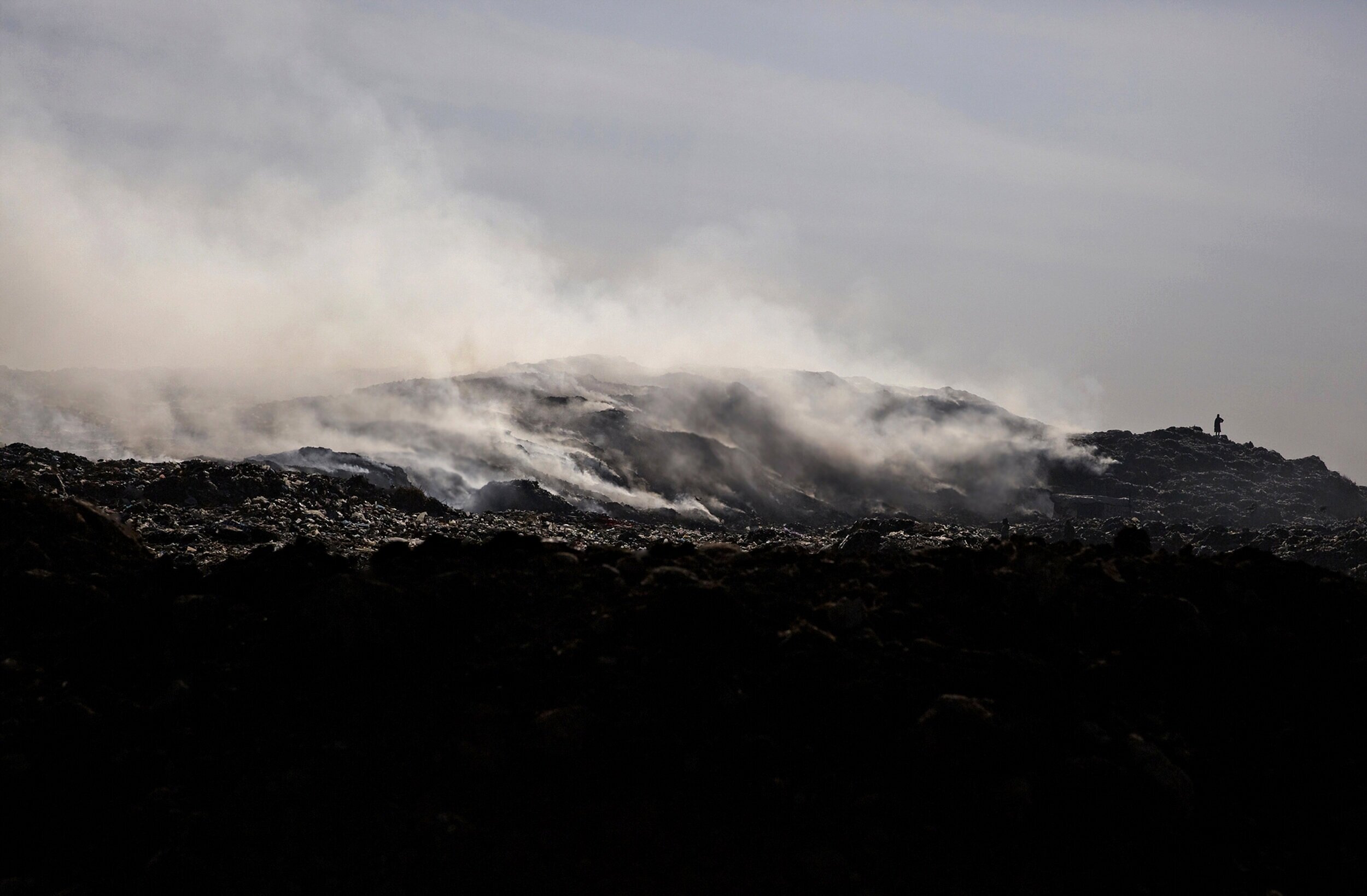  Constant plumes of smoke as seen in the Koshe landfill. In sites like this that don’t cover their waste, decomposing biological materials creates an abundance of heat which leads to spontaneous combustion.   The smoldering fires and resulting smoke 