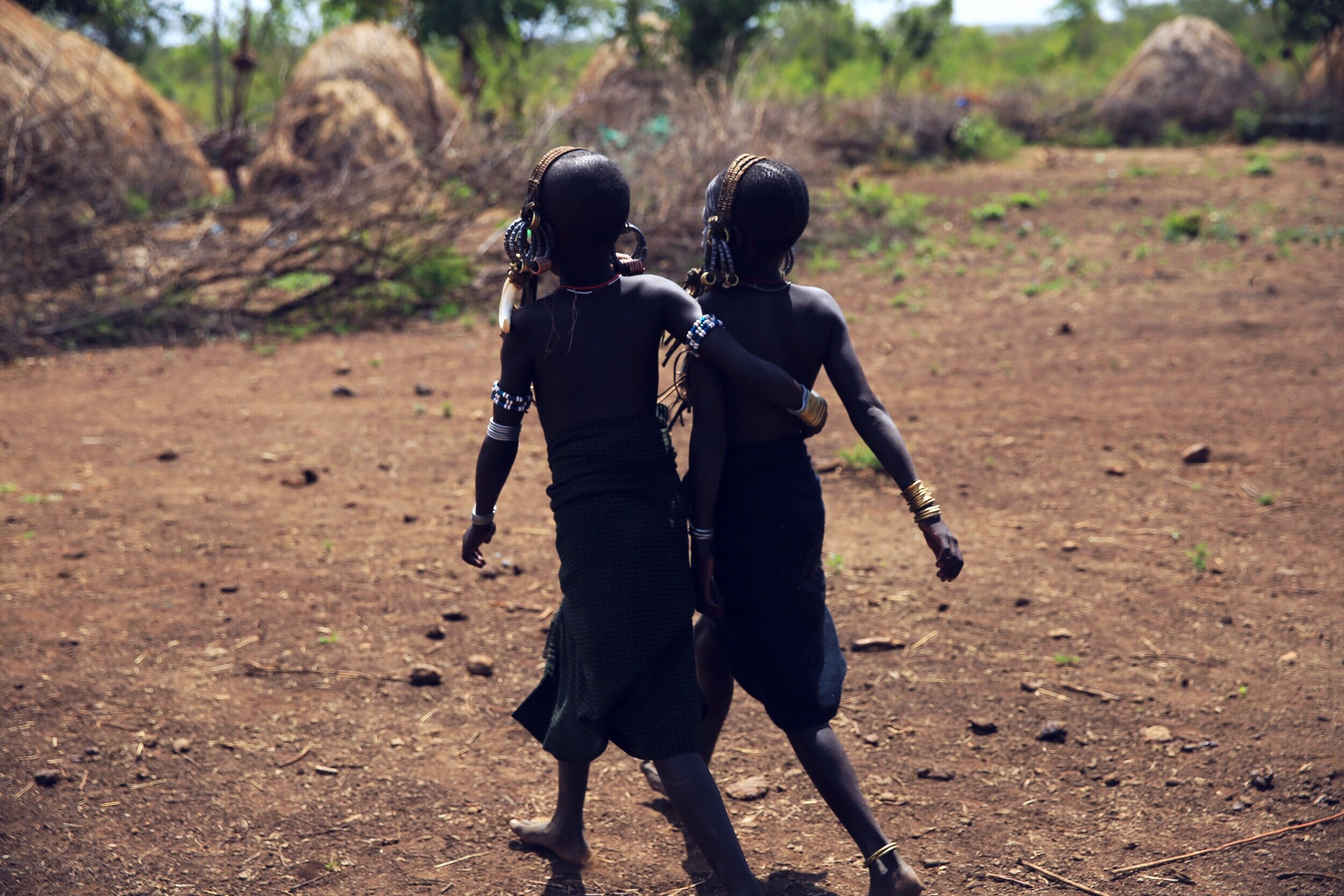  Mursi boys walk arm in arm  Southern Territories, Ethiopia 