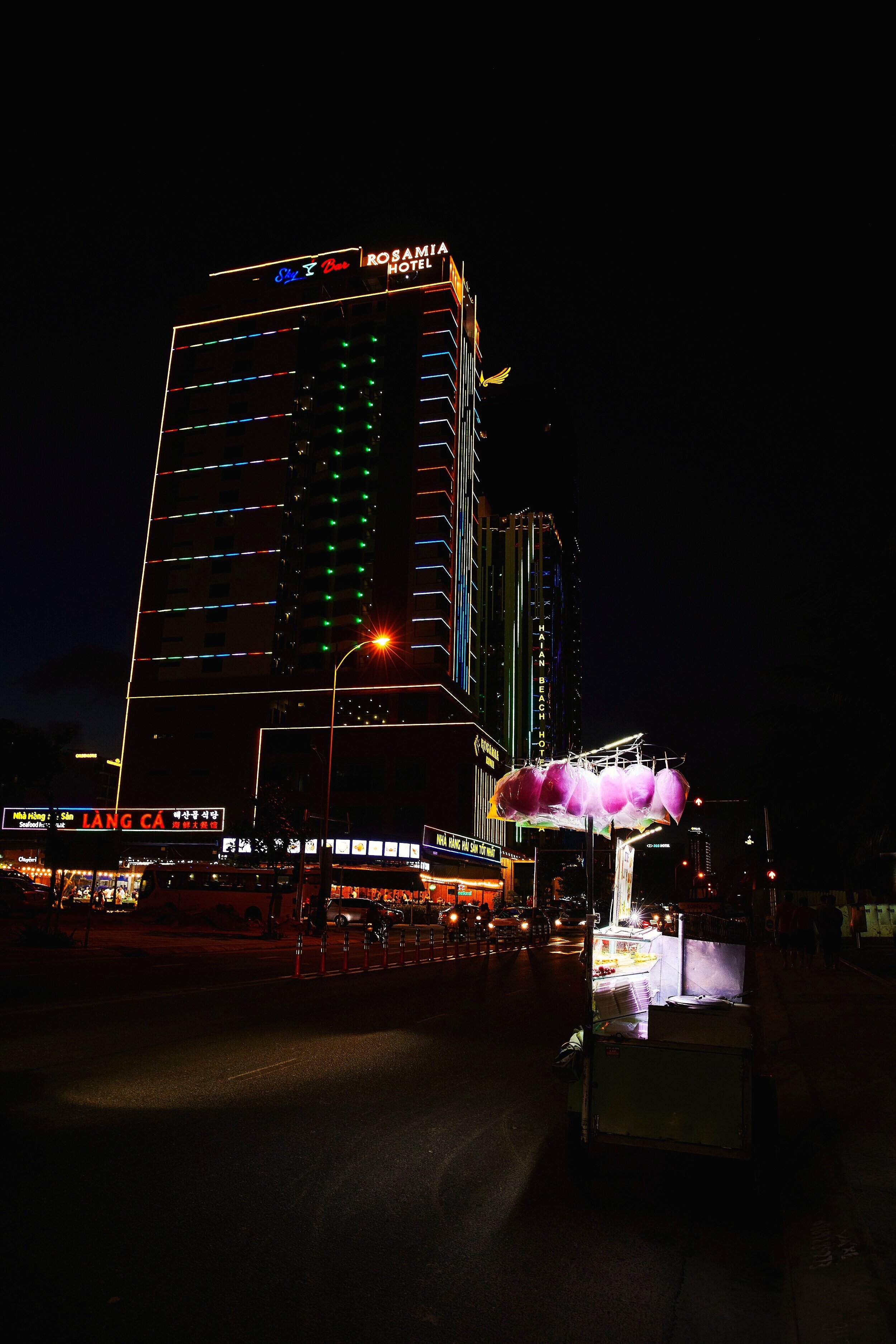  A cotton candy seller next to the beach as night falls in Da Nang, Vietnam.  