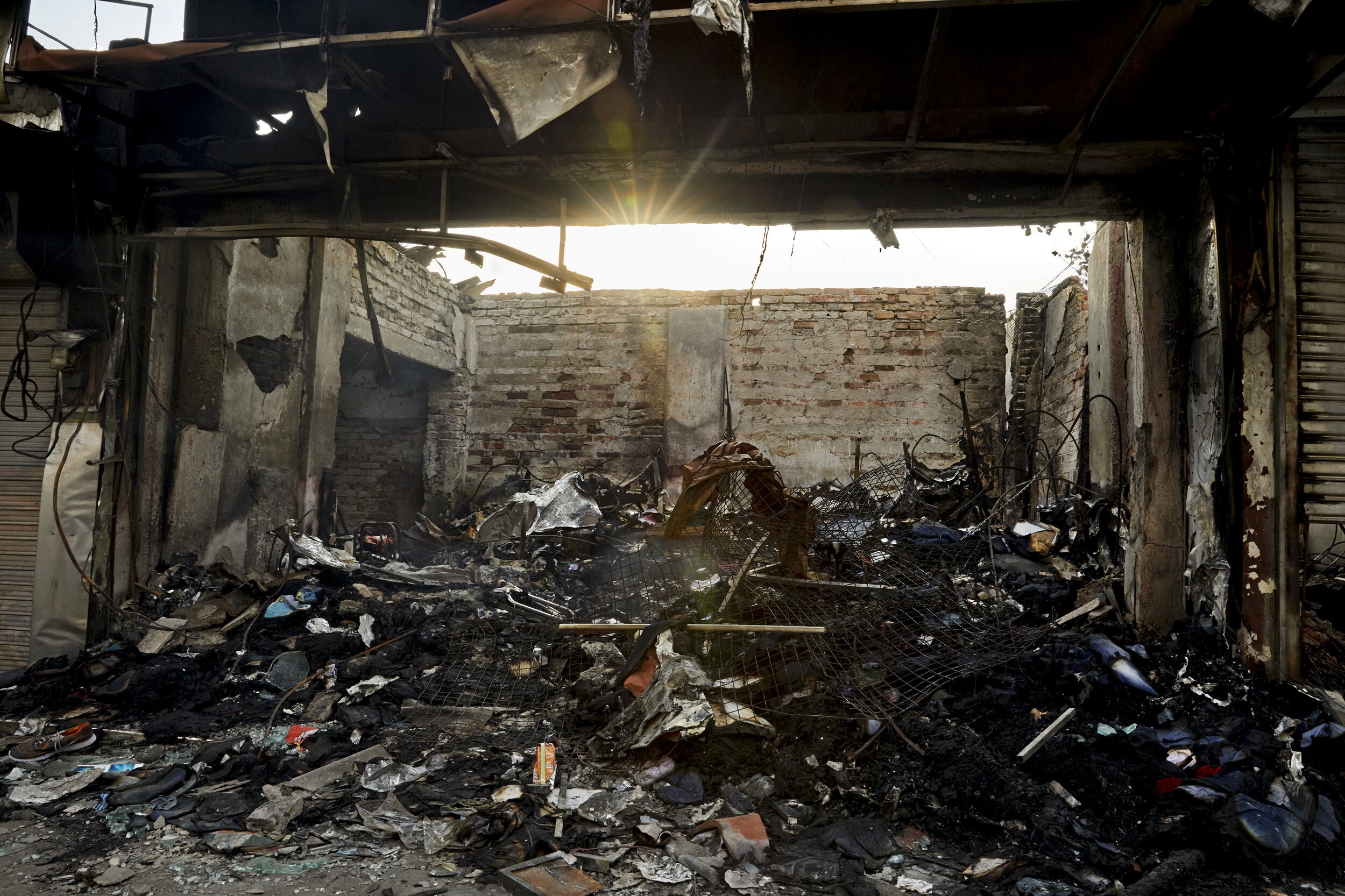  The remains of a clothing store that was set fire to. In retaliation for the bombings, people began looting mosques and burning down Muslim-run businesses, with a nationwide curfew enacted for weeks to try to stem the violence.  