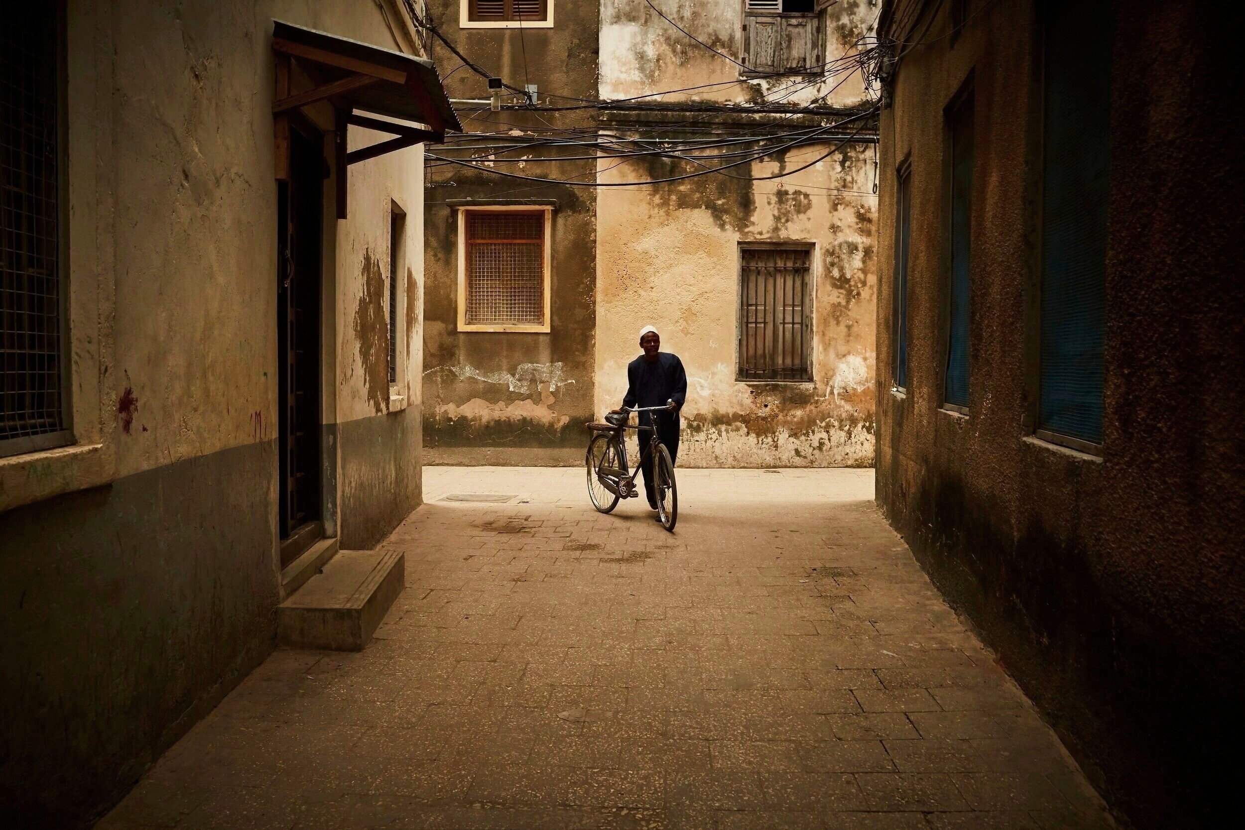   Maze-like streets built in the early 1800s. Its passageways are too narrow for any cars to traverse, so people must either walk, ride bicycles or mopeds   Stone Town, Zanzibar 