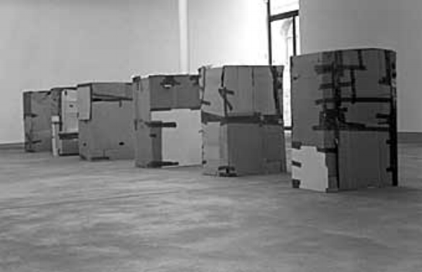 Workers Who Cannot Be Paid, Remunerated to Remain Inside Cardboard Boxes by Santiago Sierra