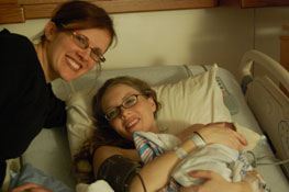 Lisa provides newborn care support as a doula at a hospital birth, immediately after the baby is born.