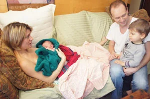 Lisa provides labor support for Virginie & Phillip (seen here with their newborn)