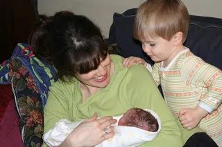 Mom, newborn, and brother, moments after homebirth in Queens (BirthMattersNYC blog)
