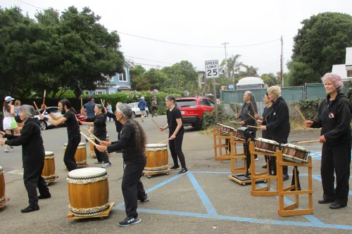 Taiko drummers drumming.