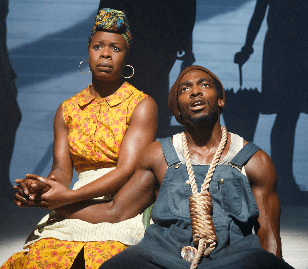 Roslyn Ruff (left) as Black Woman with Fried Drumstick and Daniel J. Watts as Black Man with Watermelon in The Death of the Last Black Man in the Whole Entire World AKA the Negro Book of the Dead. Top, Watts (right) with, from left: Amelia Workman as Queen-Then-Pharaoh Hatshepsut, David Ryan Smith as Before Columbus, Nike Kadri as Yes and Greens Black-Eyed Peas Cornbread and Reynaldo Piniella as And Bigger and Bigger and Bigger.