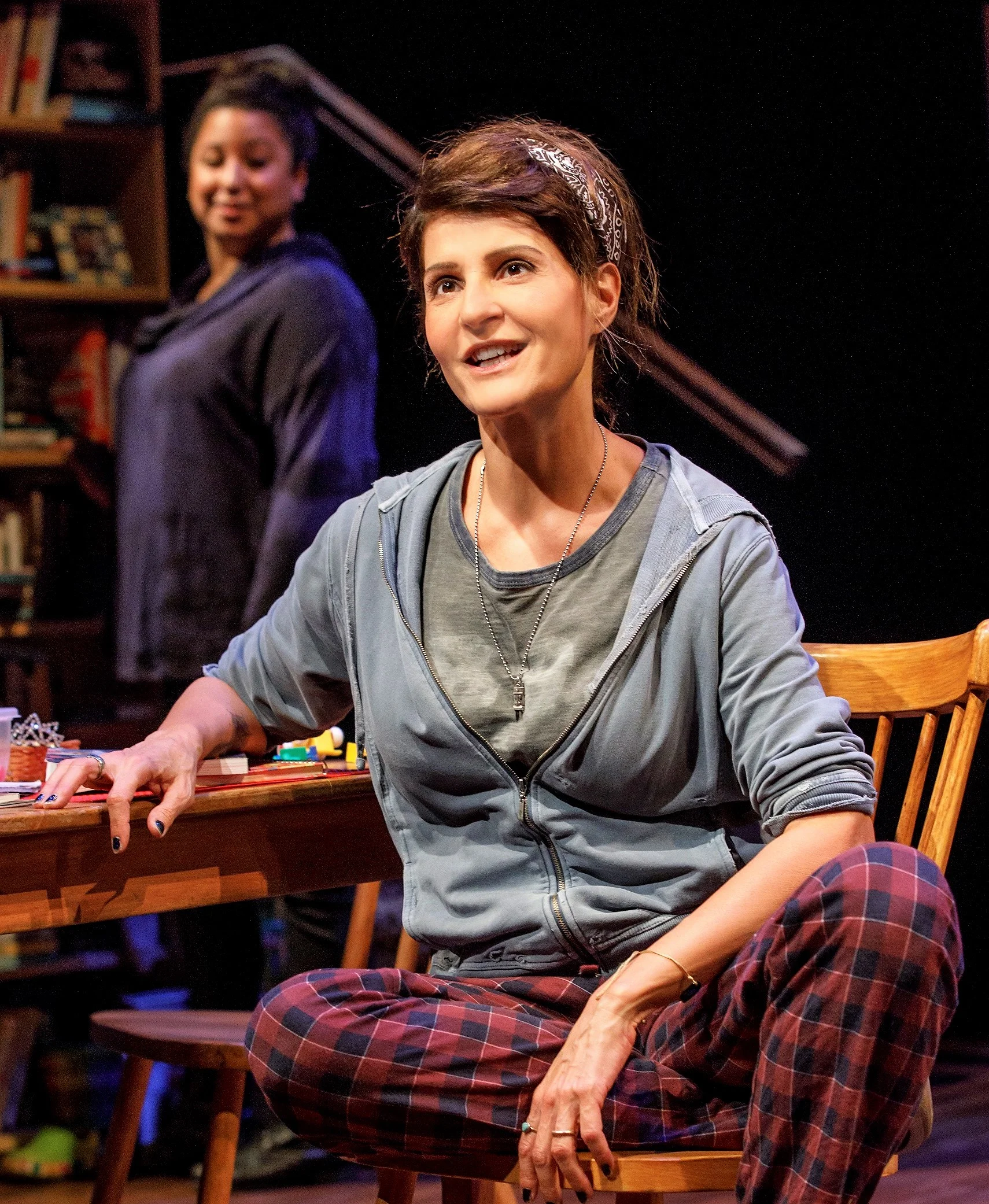 “Sugar” (Nia Vardalos) shares her hard-won wisdom with a reader (Natalie Woolams-Torres). Top: Hubert Point-Du Jour and Vardalos.