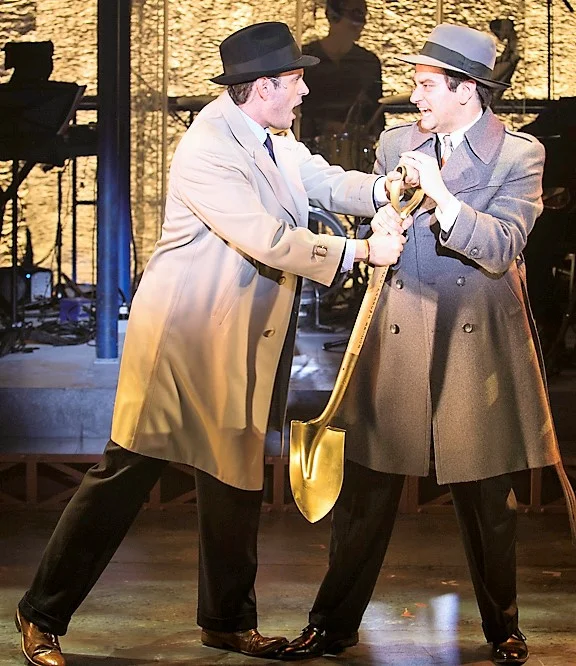 Wayne Wilcox as Nelson Rockefeller (left) and Constantine Maroulis as Robert Moses in Bulldozer: The Ballad of Robert Moses . Top: Wilcox appears behind Maroulis (right) as Moses speaks to reporters in a scene from Bulldozer . Photographs by Michael Blase.