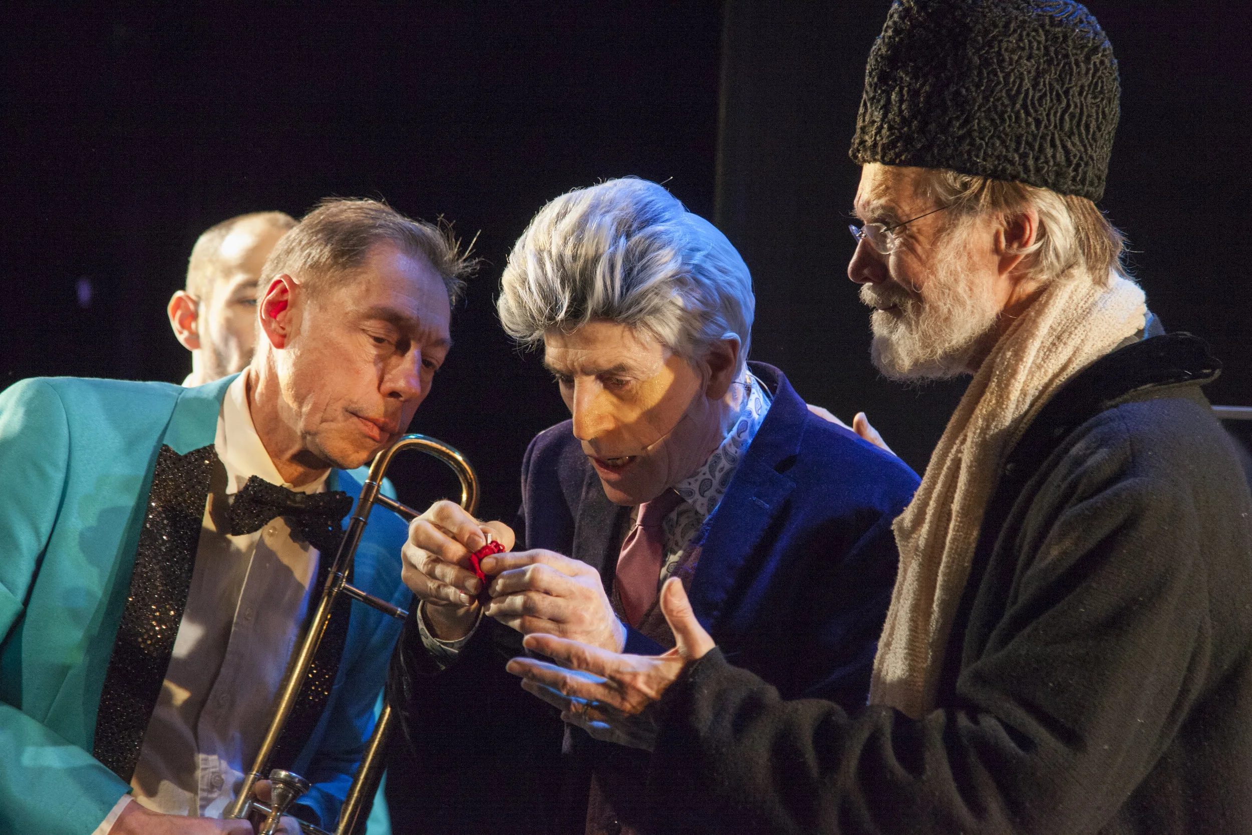 Decker and Grey with Peter Zummo (left, holding a trombone) examine a clue given by their favorite friend, “Anne Green.” Photographs by Suzanne Opton.