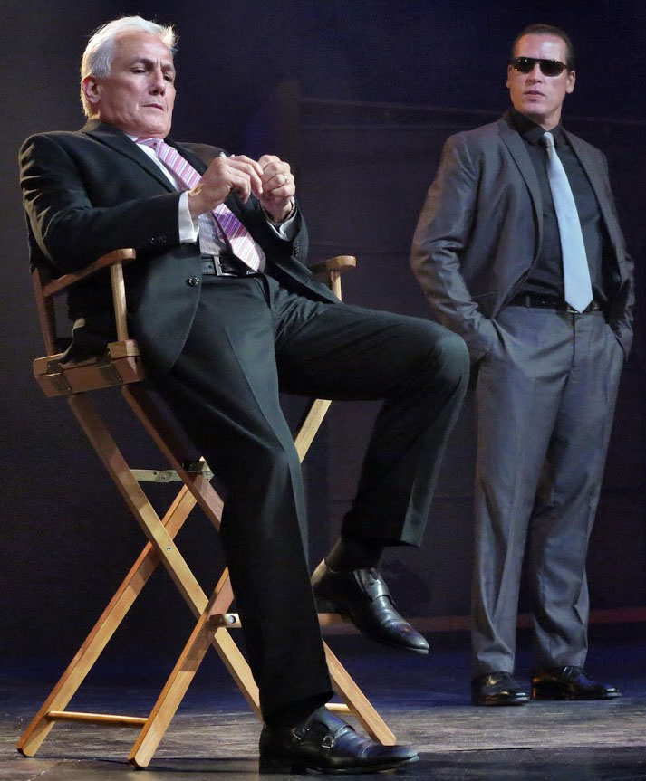 The devious head of a television network (Chad Restum) is accompanied by a bodyguard (Thomas Hildreth). Photographs by Jonathan Slaff.
