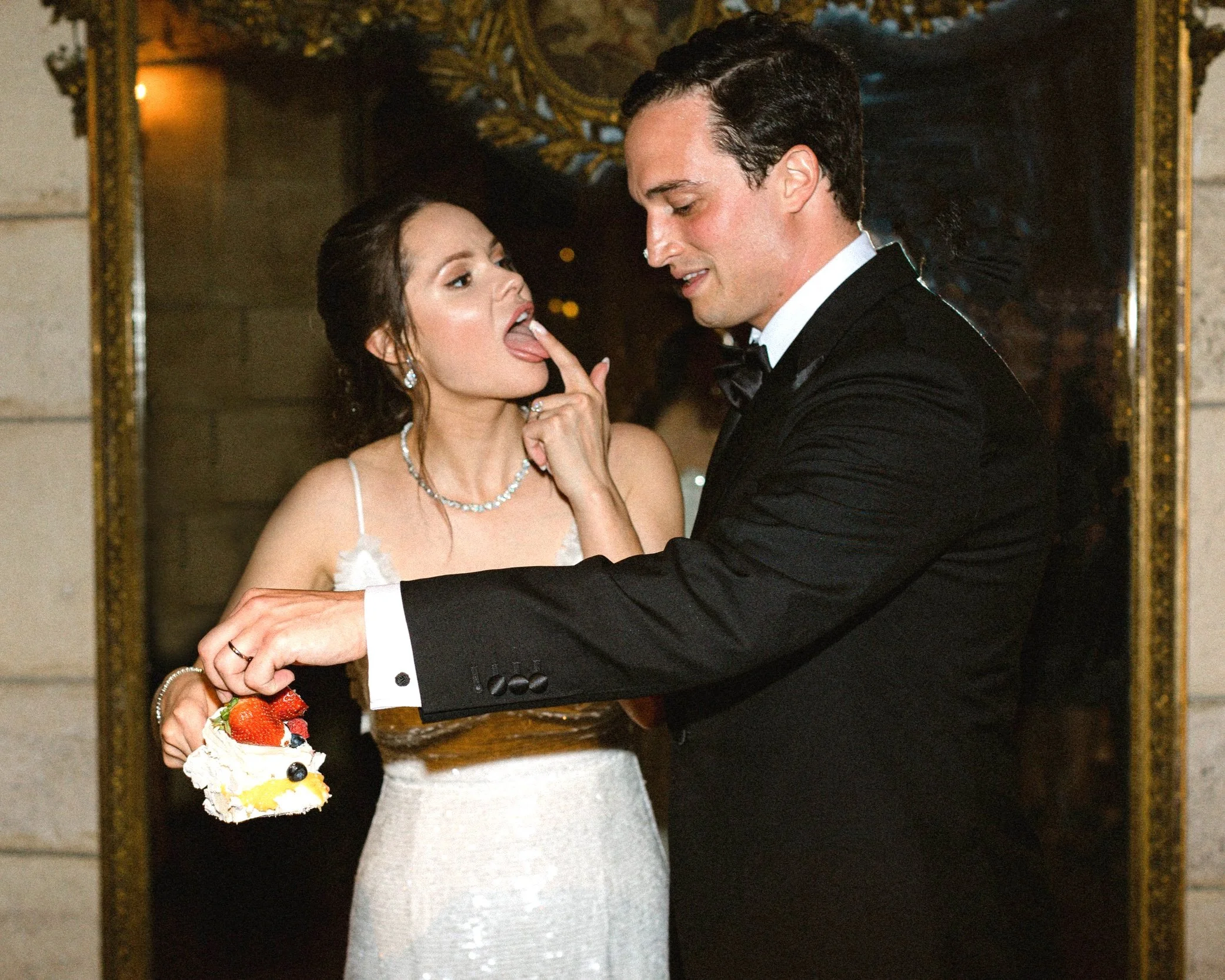 Bride and groom cake cutting during their wedding reception