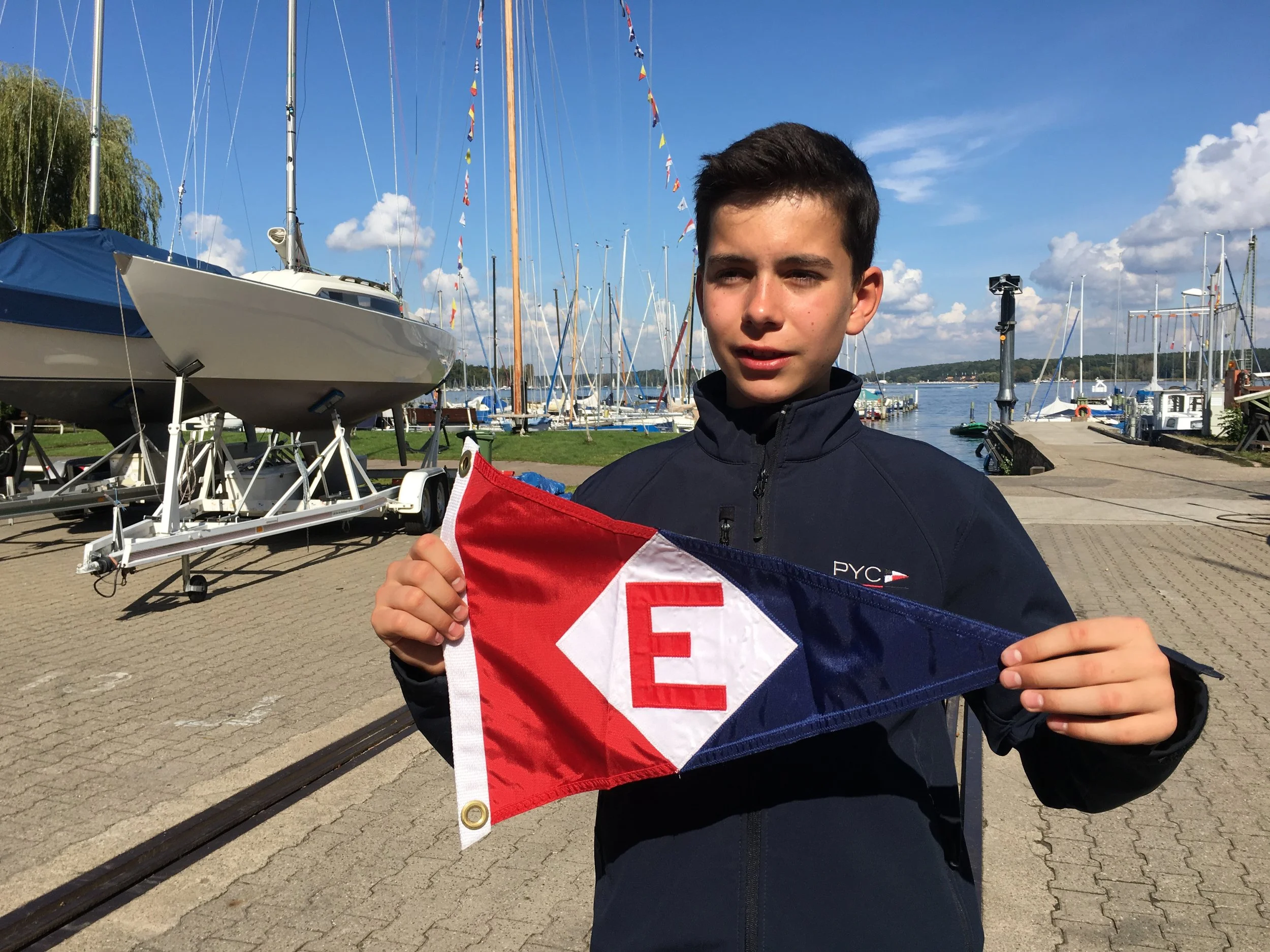 Hendrick and his mom Sigrun visited our club last summer and exchanged burgees with from their club with EYC. Here's Hendrick at Potsdamer Yacht Club in Germany showing our colors.