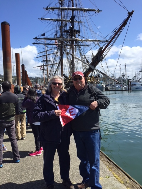  Kathy and Paul  hoist the colors in front of tall ship Lady Washington in Newport, Oregon 