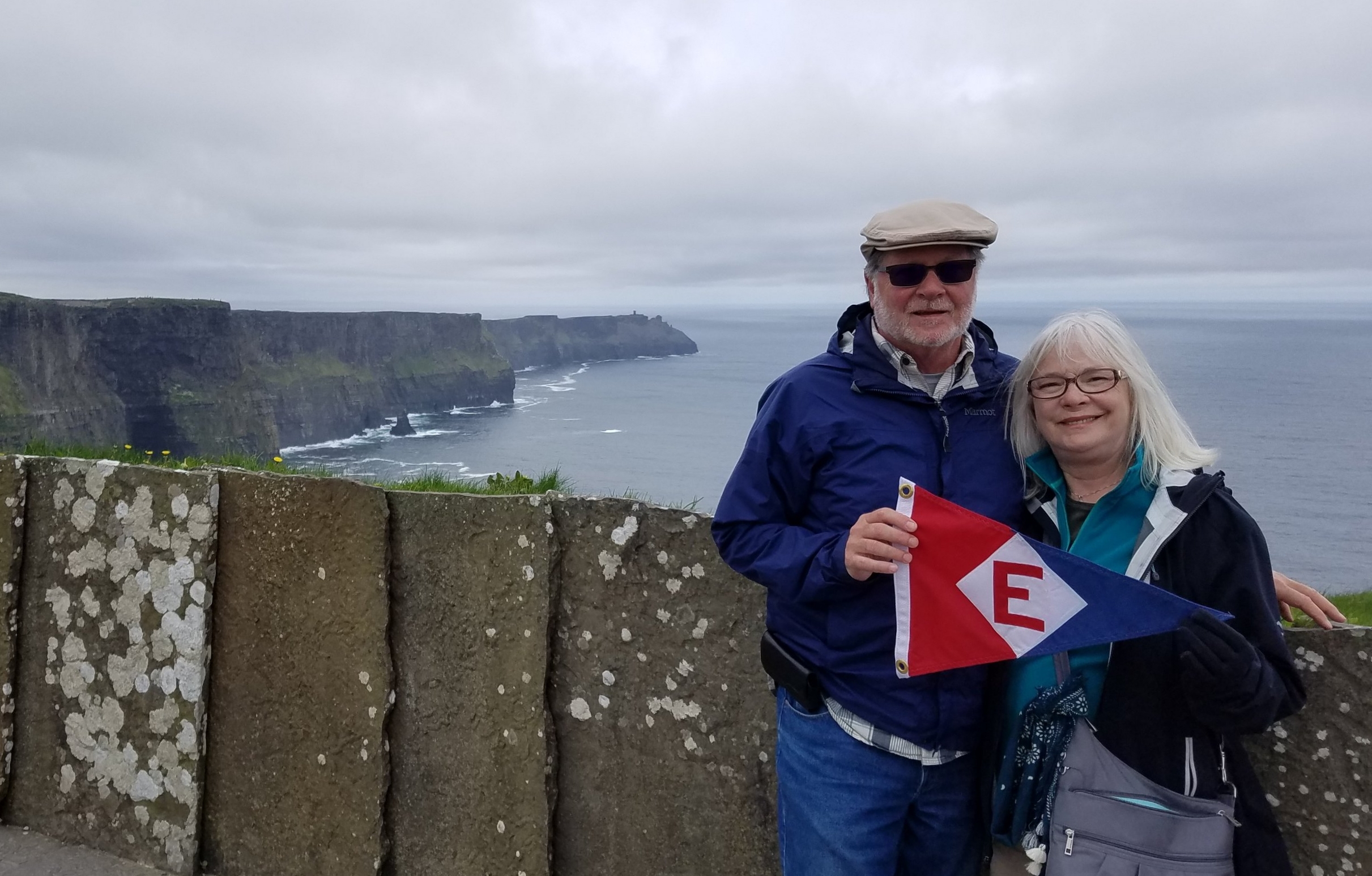  Murray and Linda fly the EYC burgee from the Cliffs of Moher in Ireland. 