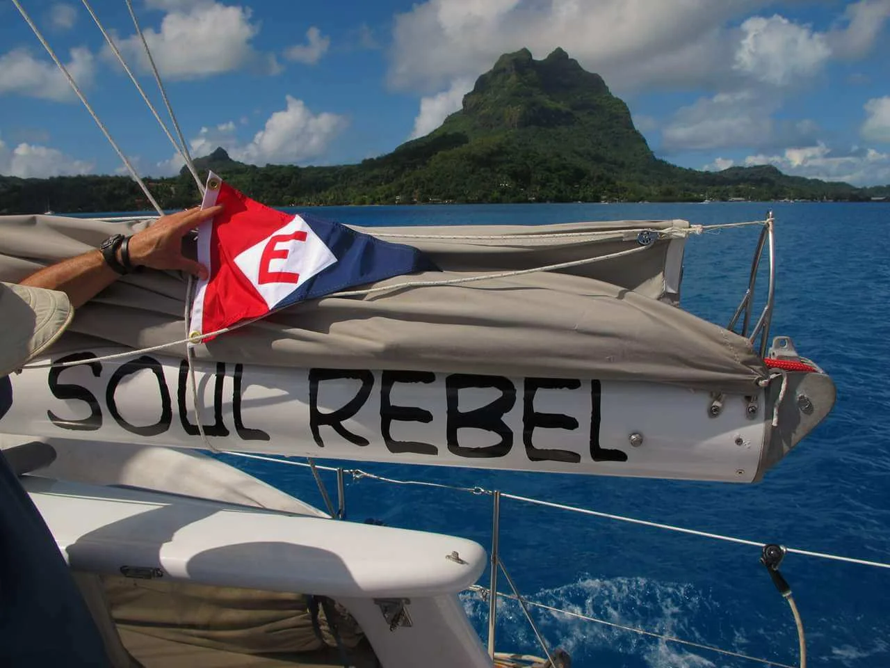 Roger Bailey hoists the colors in Bora Bora on his retirement cruise