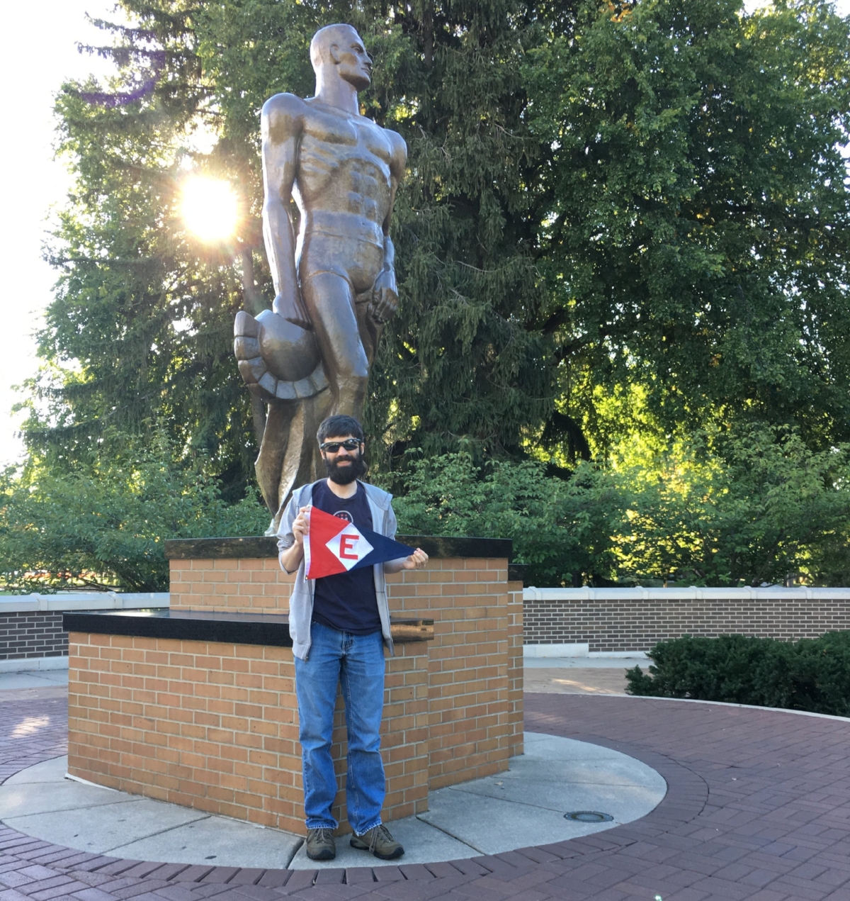 Alex Aaring, son of Rich & Dixie Aaring, shows a little EYC pride at the foot of The Spartan on the Michigan State campus