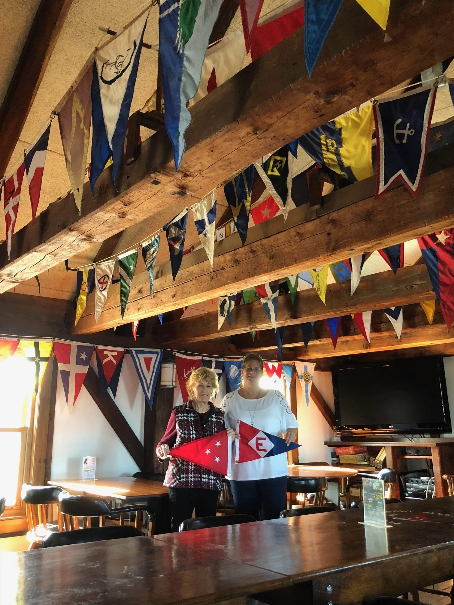 Blanche Chase exchanges burgees w ith the Commodore of the Plymouth Yacht Club in Plymouth, Massachusetts