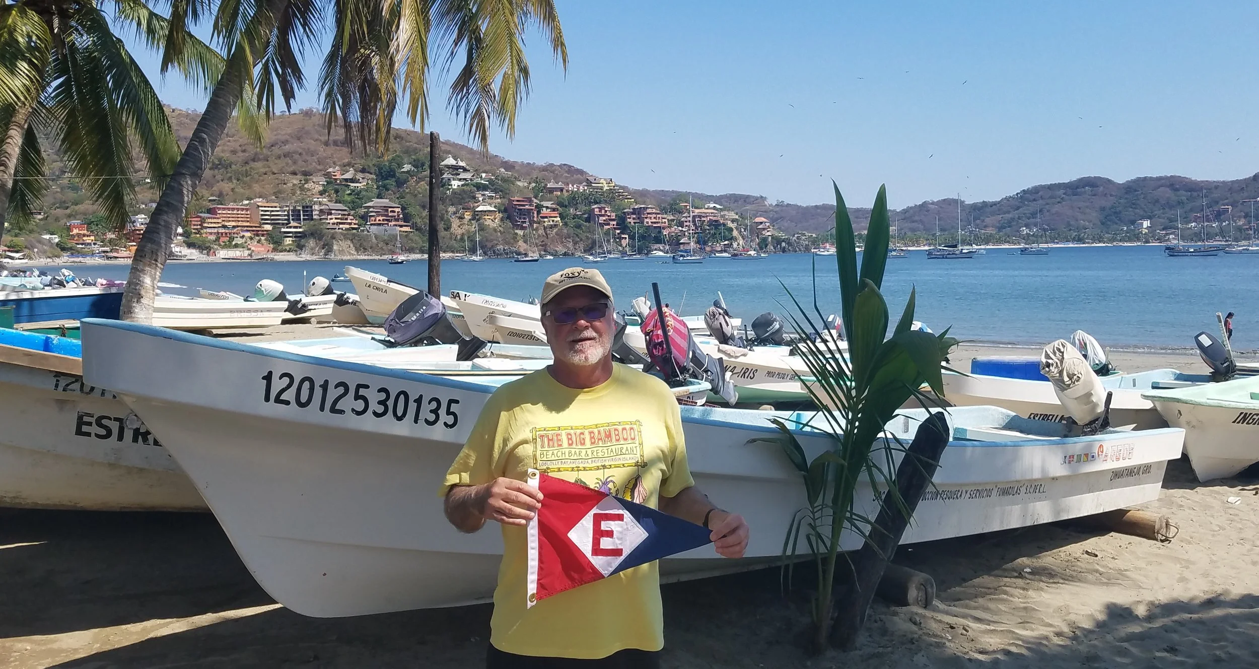Murray McLeod hoists the colors in Zihuatenego, Mexico