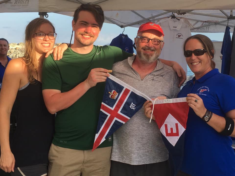 Kimi, Jac, and Chris make a burgee exchange with Royal BVI Yacht Club manager Tamsin Rand.  The EYC  burgee will be the first new one to grace their new club house after Hurricane Irma. 