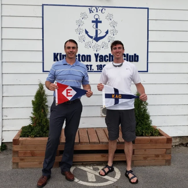 Langdon exchanges burgees with the Commodore of the Kingston Yacht Club in Ontario, Canada
