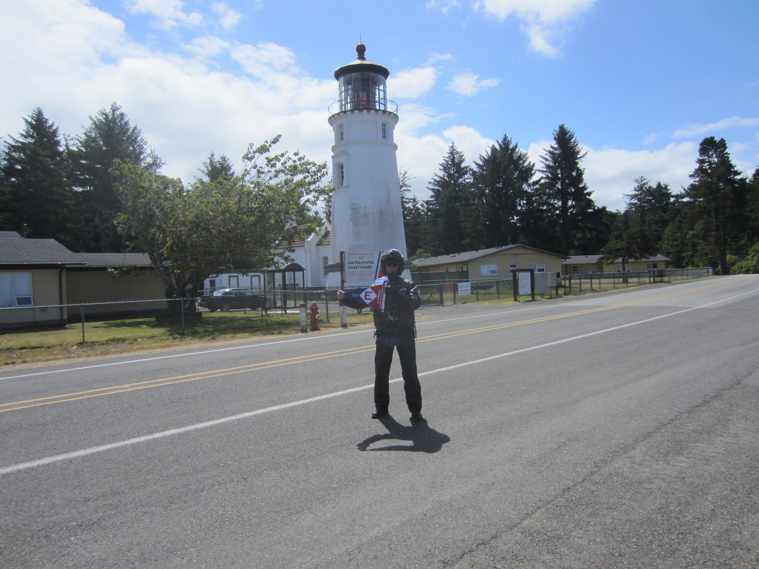  Gordon hoists the EYC colors at the Umpqua Lighthouse in Winchester Bay, Oregon 