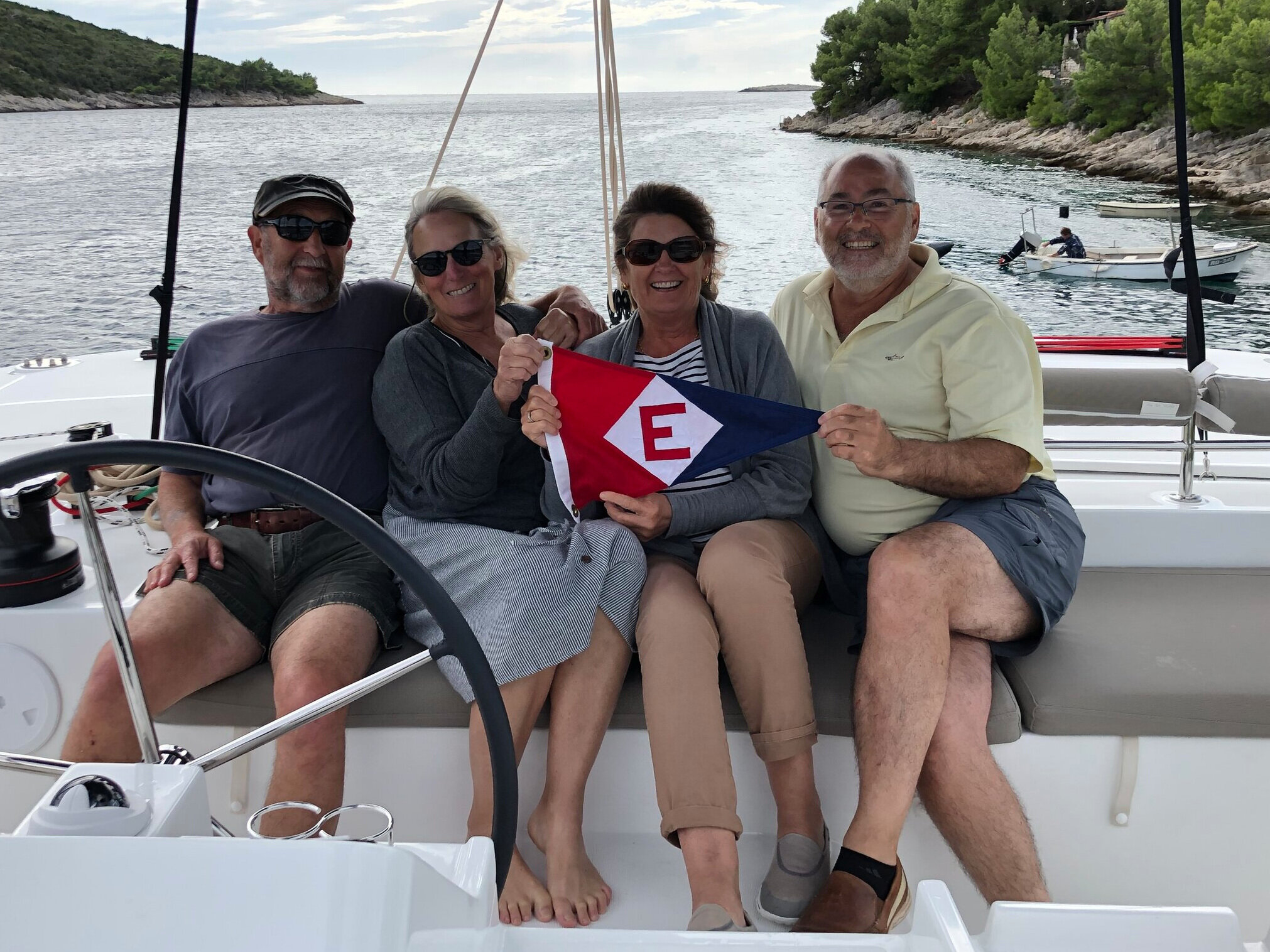  René and Lynne and Shelley and Nick show their EYC pride while cruising off the Dalmatian coast in Croatia 