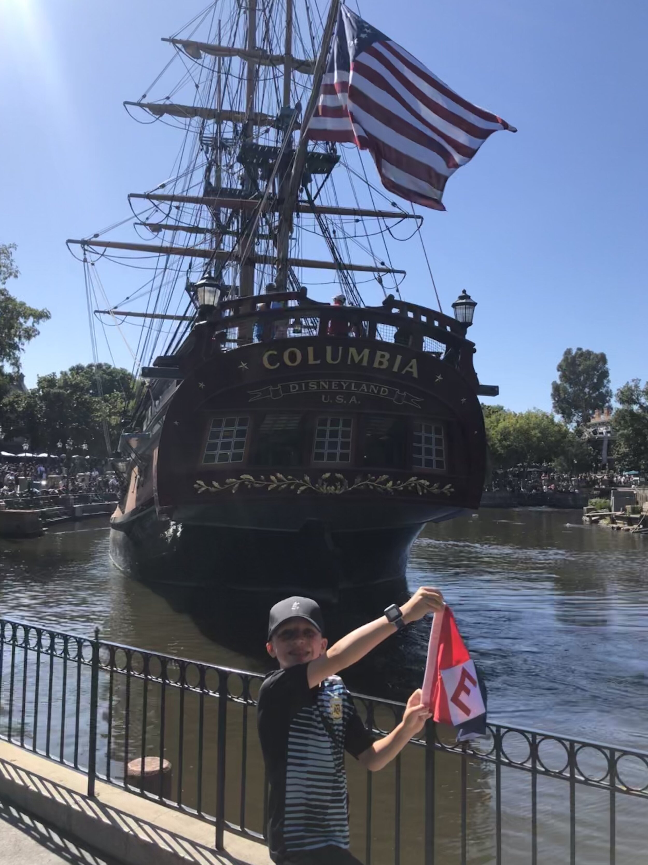  Zachary hoists the EYC colors in front of the Columbia at Disneyland 