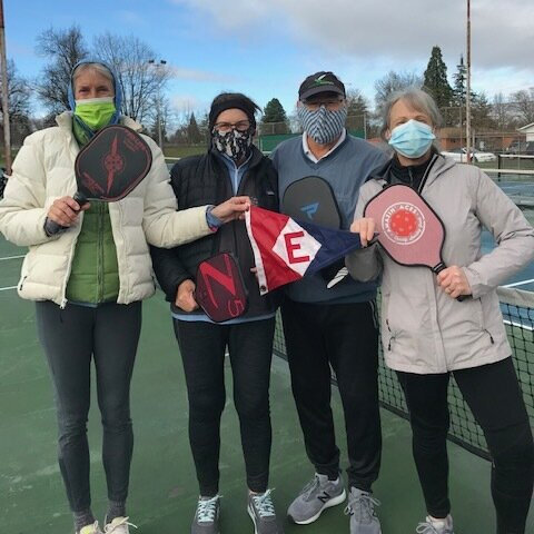  These masked EYC supporters show their colors between pickleball sets 