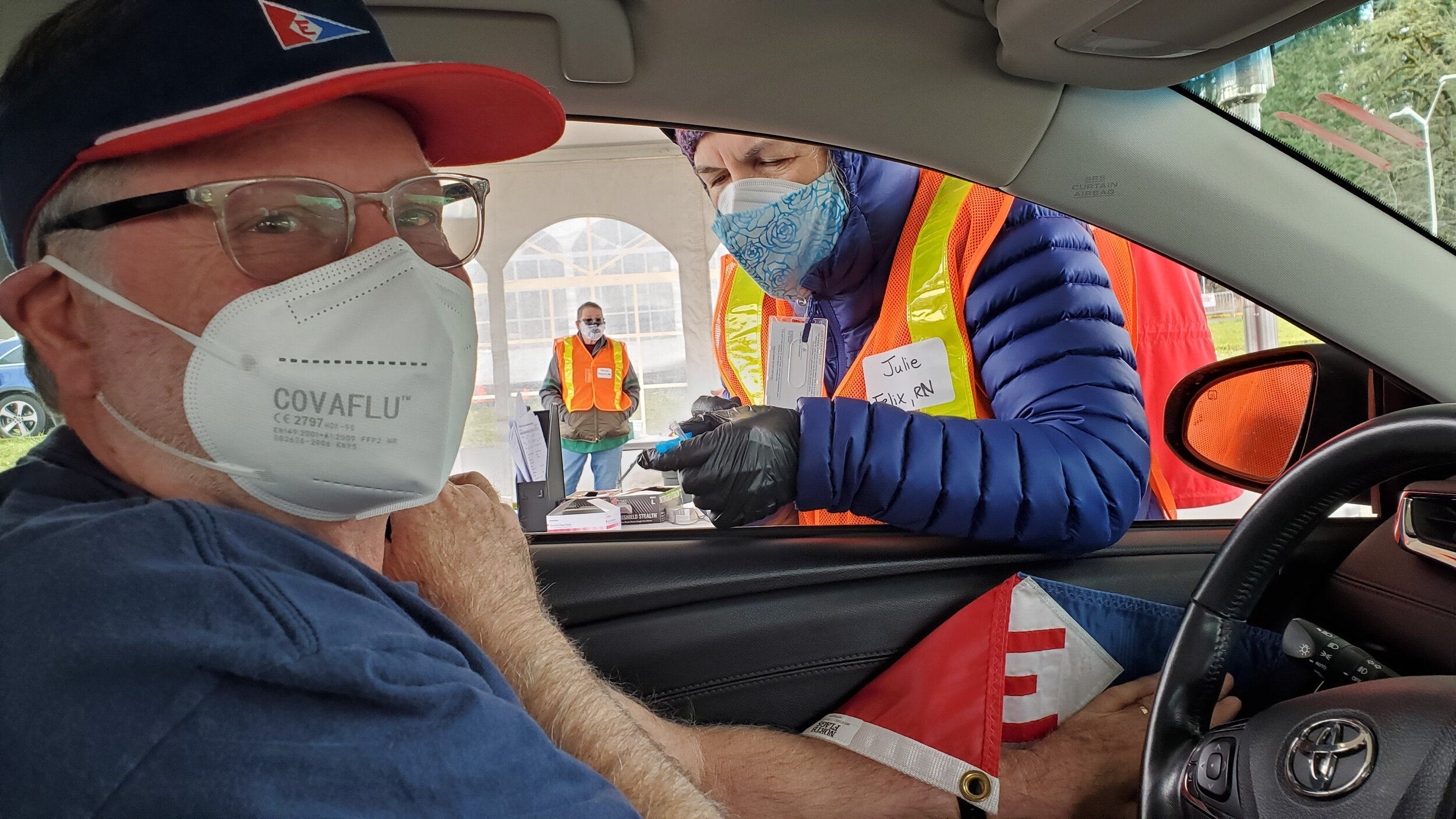  Murray hoists the colors for his drive-through vaccination  