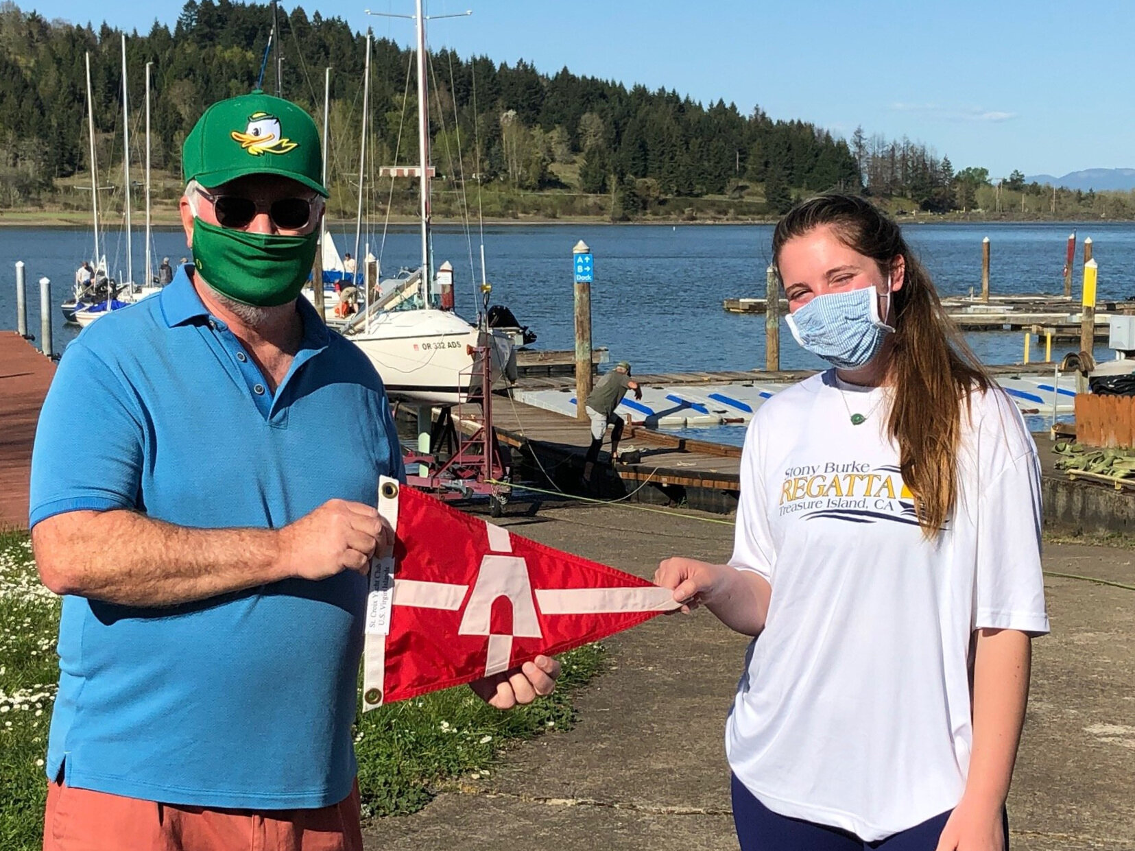  Tillie from the UO Sailing Team presents the St. Croix Yacht Club burgee (US Virgin Islands)  to Commodore Richard Johnson 