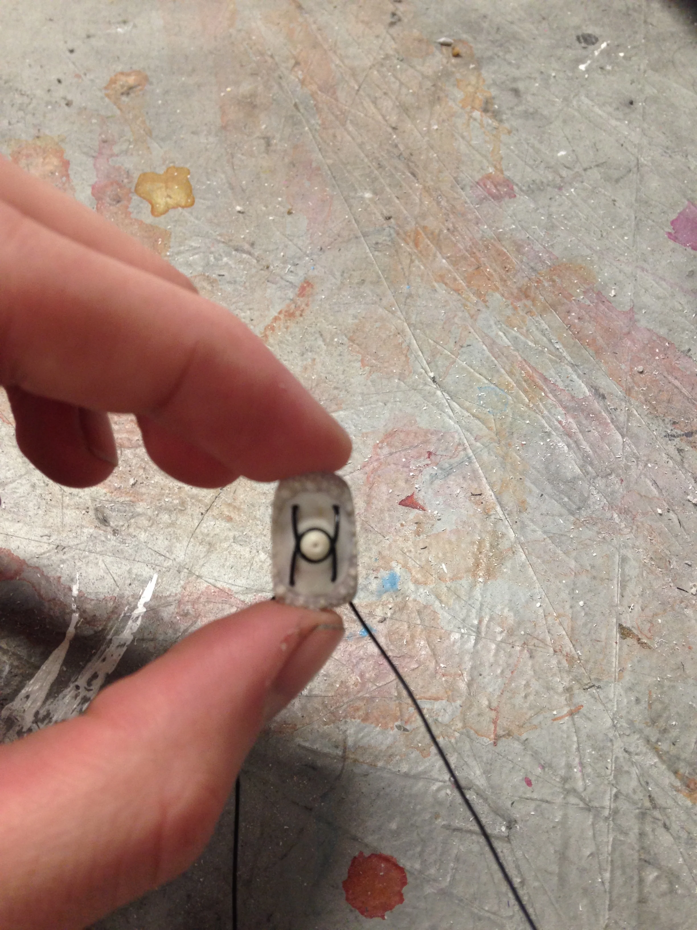 I found a way to wrap the elastic around the round protruding form of the sea urchin piece. This method of weaving the pieces together effectively engages with the form of the sea urchin pieces and adds visual interest.