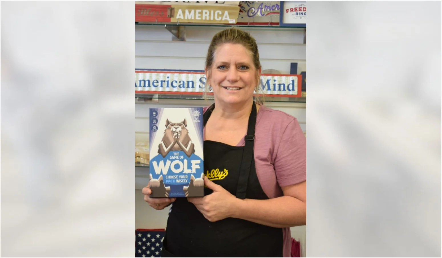 Deborah Prescott | Daily Press Sales associate Chrisy Grandahl holds The Game of Wolf at Sayklly’s Confectionary and Gifts on North Lincoln Road Tuesday afternoon. The game is the latest creation from Joe Barron, a 2001 graduate of Escanaba High School. Barron and his wife Lauren created a business called Gray Matters Games. Their goal is to get people away from their cell phones and tablets and interact with other people by playing games while supporting brain health. A portion of proceeds go toward Alzheimer’s disease research