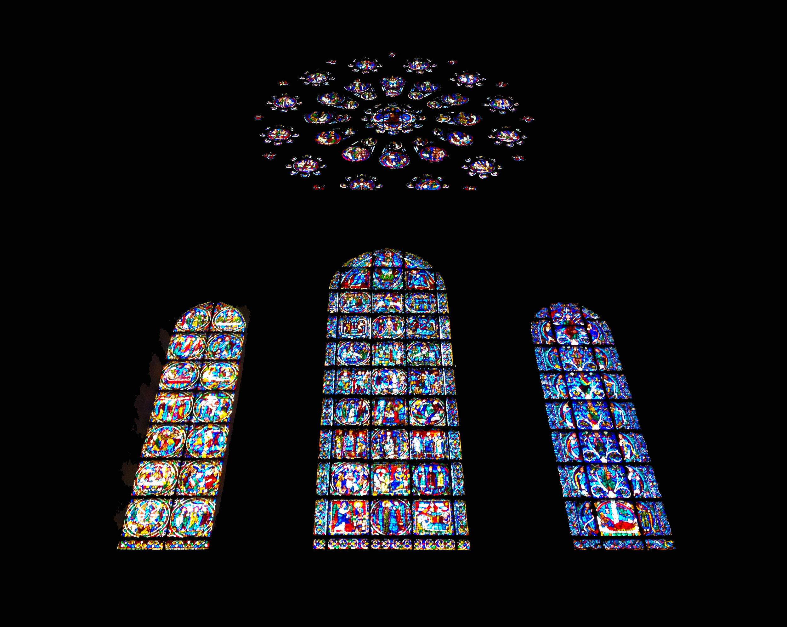  The cathedral at Chartres is known for its stained glass. This is one of its three rose windows, with lancet windows below depicting (from left to right) Christ's death, birth, and the Tree of Jesse. 