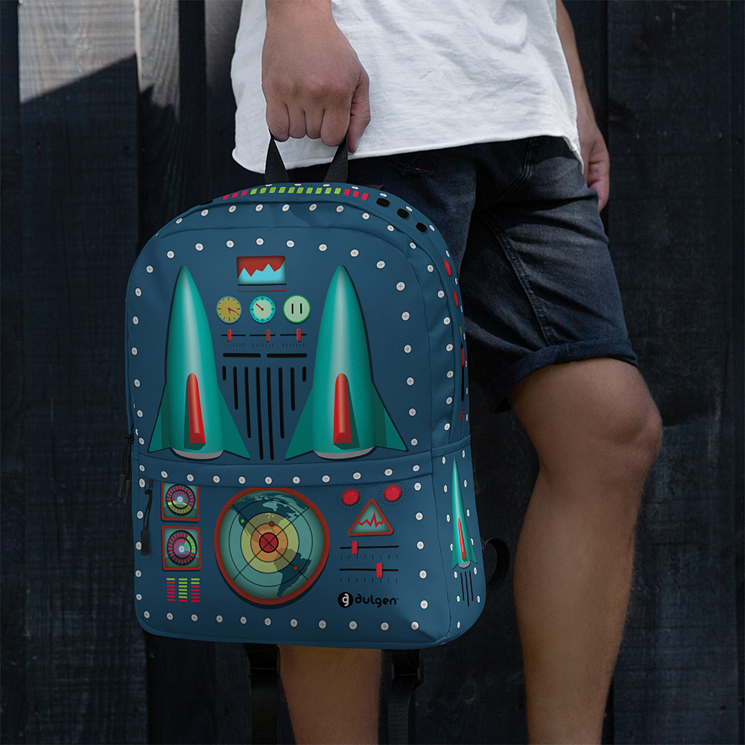 Man carrying the 50s Rocket Jet Backpack by the top handle, showcasing the vibrant tin toy pattern.