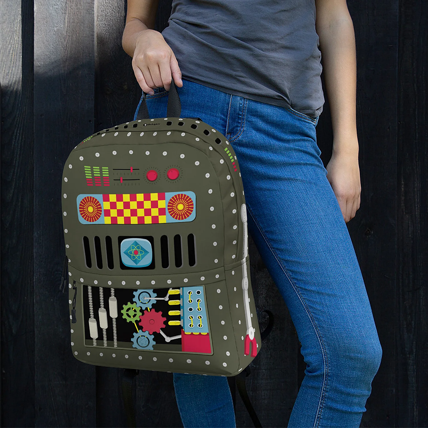 Woman carrying the 50s Robot Backpack by the top handle, showcasing the vibrant tin toy pattern.