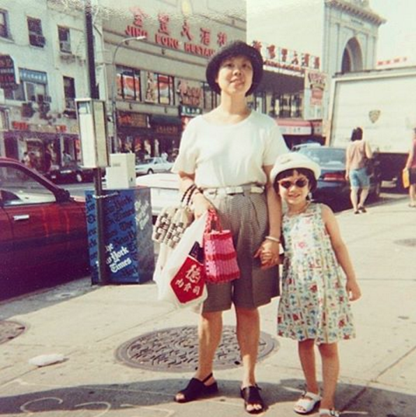 My mother and five-year-old me posing together on the Bowery in Chinatown. My father probably took this picture after my mother and I did some hard bargaining at the fruit and veggie stands. 