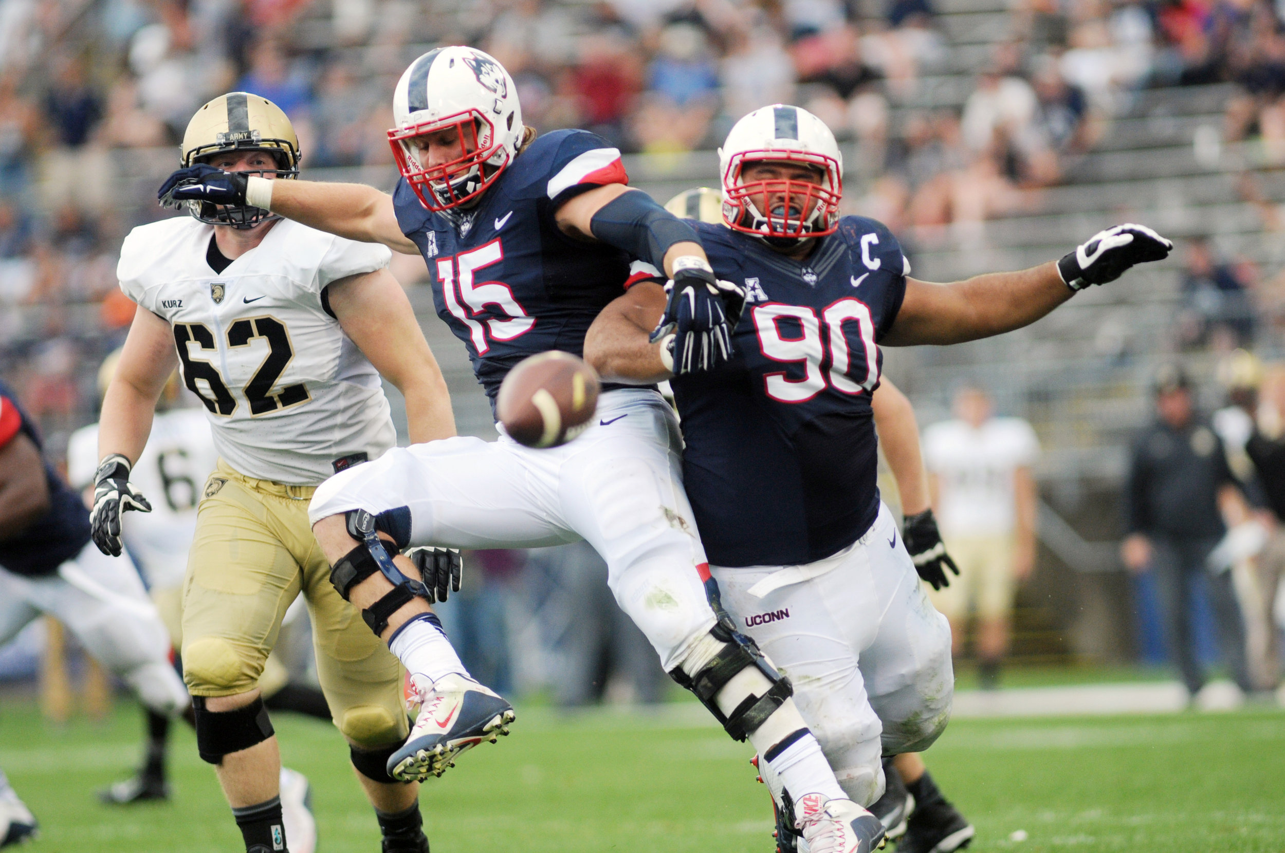  Linebacker Luke Carrezola (15) and defensive lineman Julian Campenni (90) clash for the ball at Pratt &amp; Whitney's Rentschler Field in Hartford, Conn. against Army on Sept. 12, 2015. 