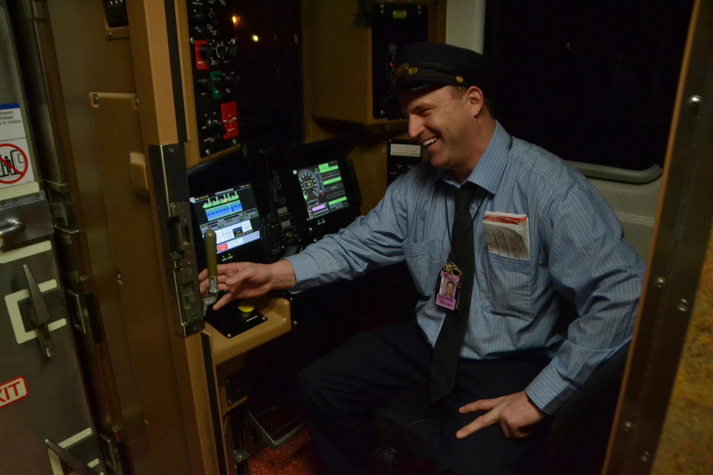  Justin Shepard, train conductor for Metro North, smiles to a coworker on Feb. 2, 2016. As train conductor, Shepard can be called in to work long shifts with no regular schedule.&nbsp; 