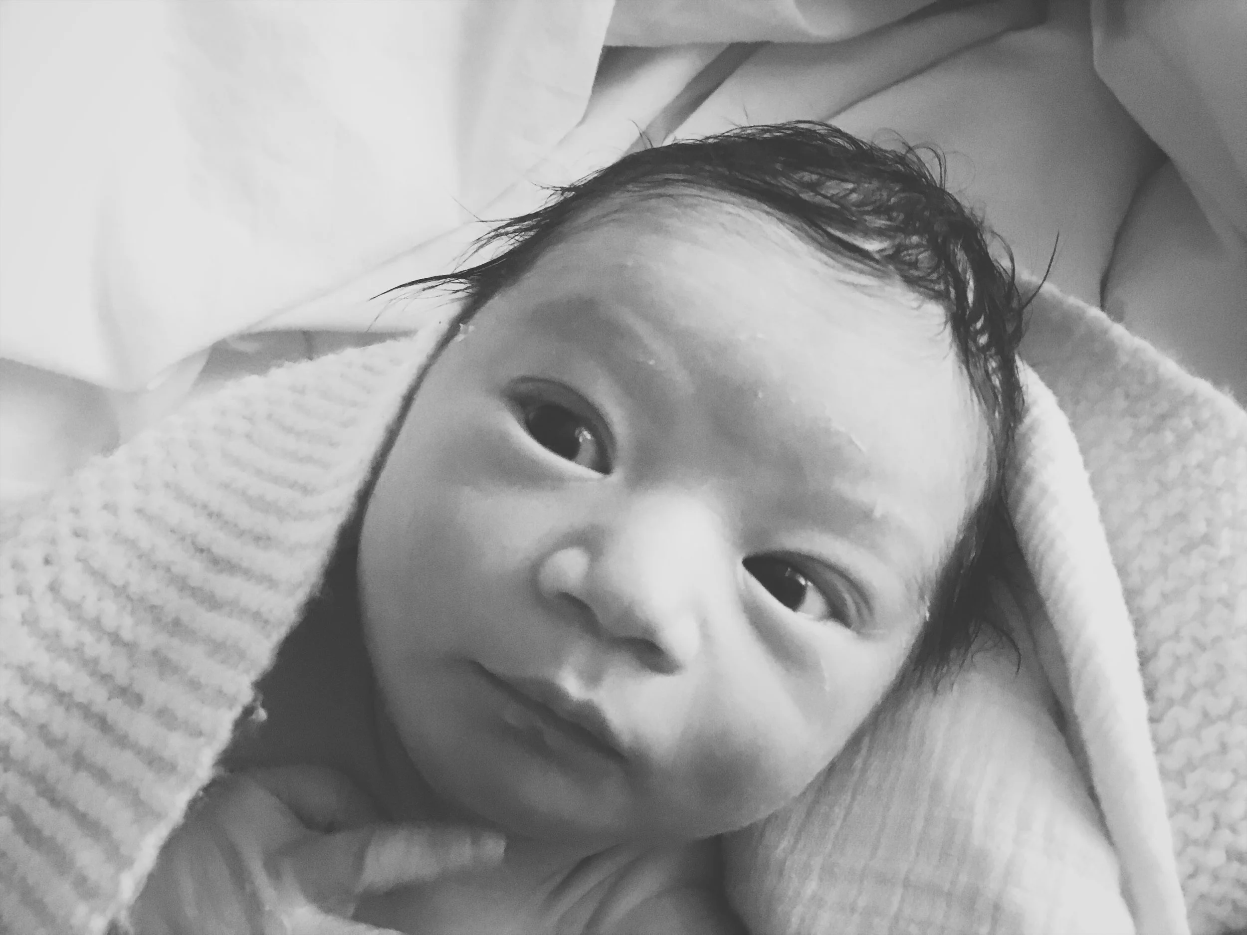 Sweet fresh born boy was so bright-eyed and alert.