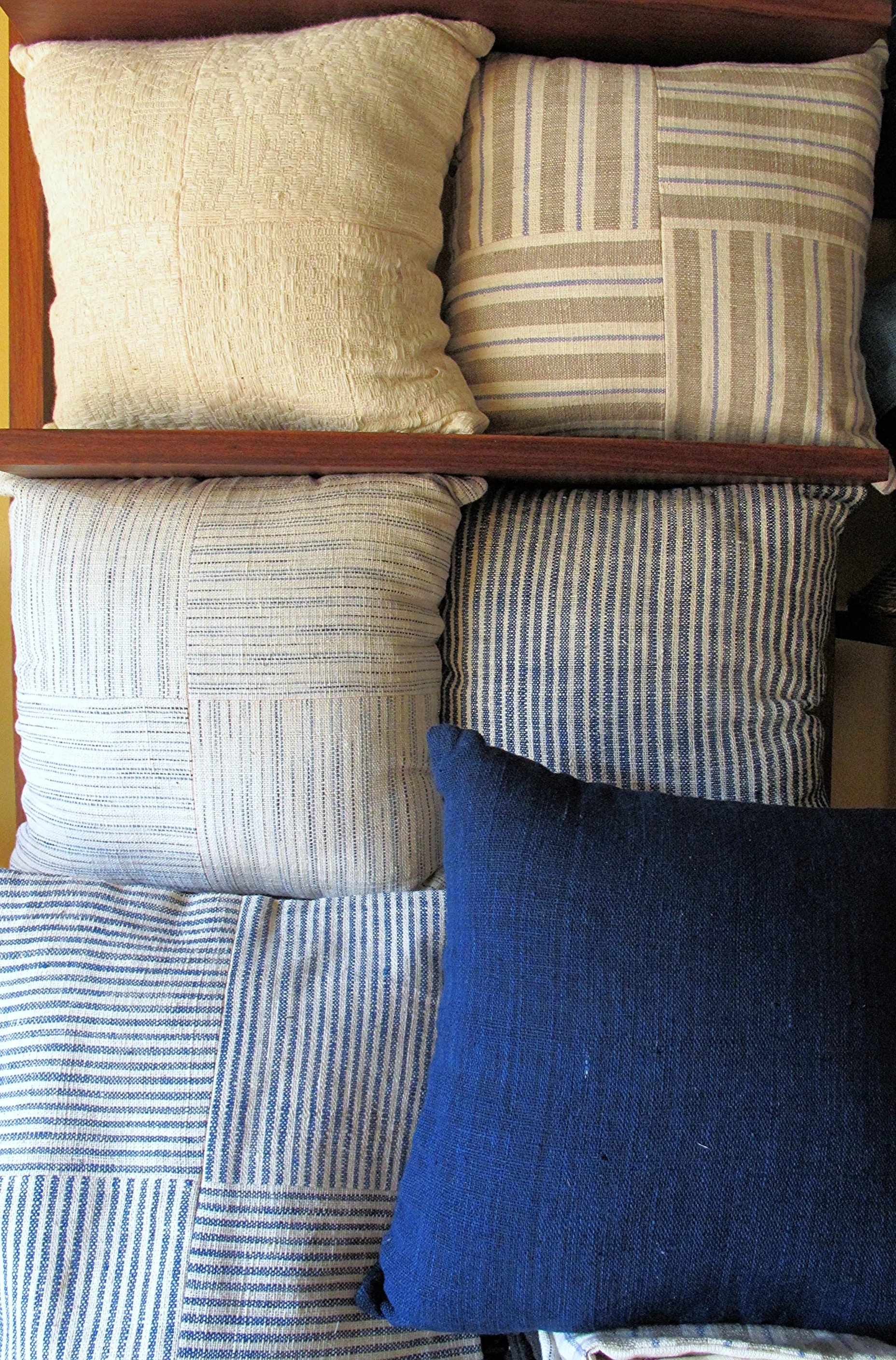 [Natural colors in peach yellow and indigo blue, in easy even stripes, cozy and soft squeezed together. Dreamy cushion covers handwoven by women of the Tai Leu ethnic group in Banayan village Laos. Also curated by Ma Te Sai .