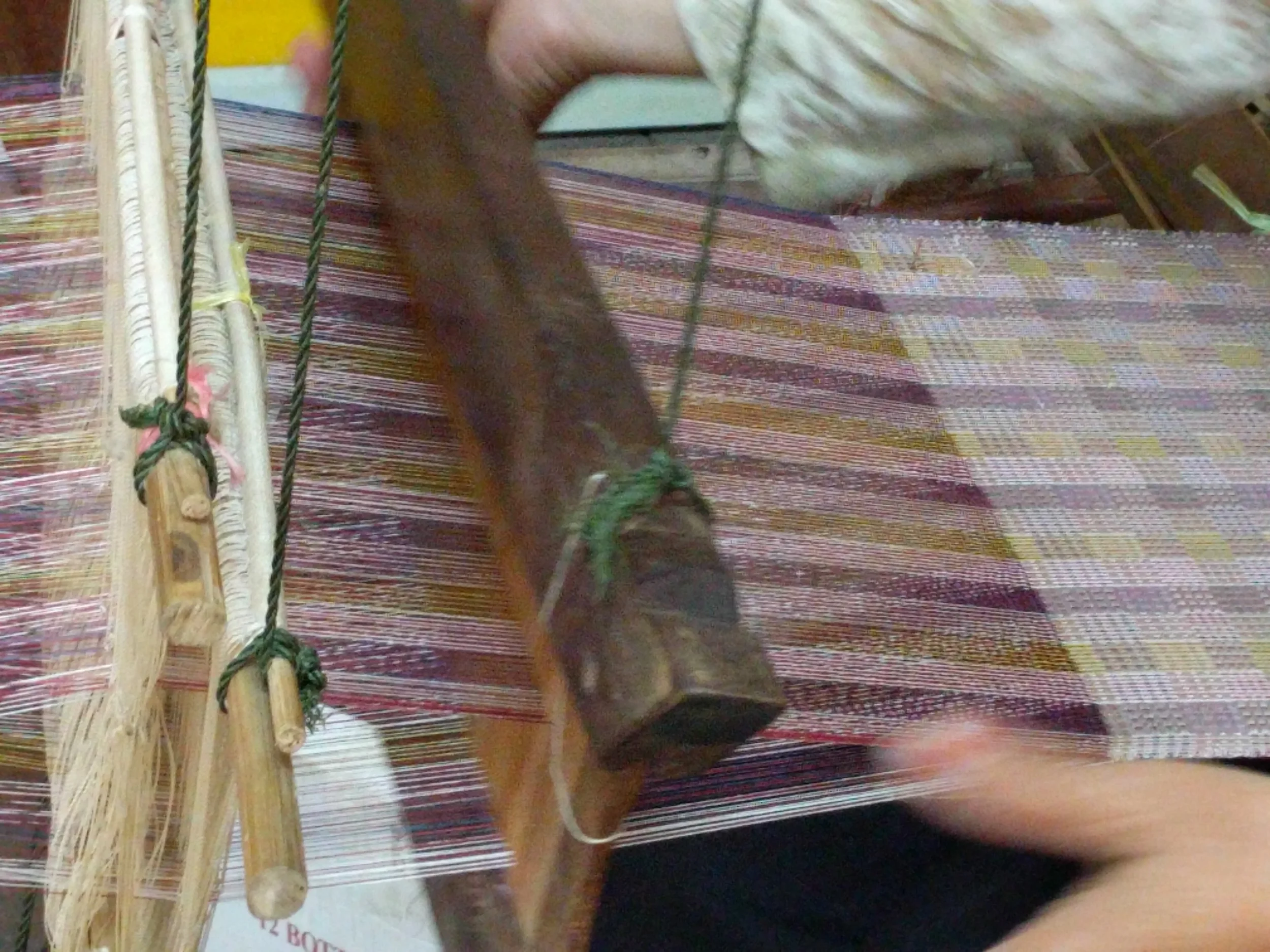 A master weaver at Khang, a center for fine silks, textile design, Lao fashion and traditional weaving in Luang Prabang, Laos.