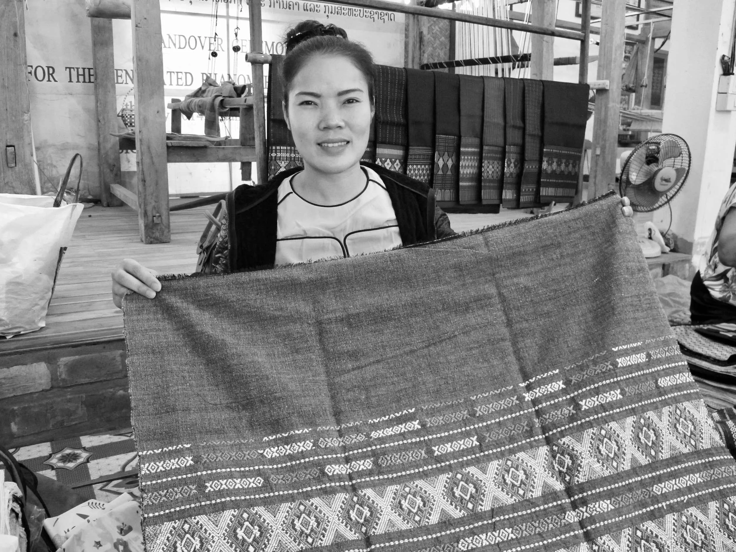 February 2018 – Ban Phanom, Luang Prabang, Laos – Ta is a master Tai Lue weaver. Her fine, well-crafted designs and natural colors are incredible. Here she is with the beautiful diamond crab design in grey green.